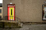 A pink and yellow doorway made a rather boring building remarkable.  Photo 13 of 20 in Colors of Iceland by Bradford Shellhammer