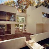 Boxy white volumes with plenty of glass are the order of the day, with a winding courtyard and a ramp down to the ground. Photo courtesy of Thom Abel.