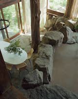 Organic architecture at its best: The sunken dining room features boulders and a more than one-hundred-year-old tree trunk that acts as the main support for the southeast corner of the house.