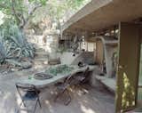Architect Paolo Soleri lives in a wood-frame house in his Cosanti complex (which includes his home, office, and workshop) in Scottsdale, Arizona. Soleri was a student of Frank Lloyd Wright and the influence of the master's organic architecture is clear in the outside dining room and work space in the southern courtyard (shown here).