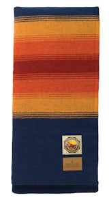 The Grand Canyon blanket has the strongest regional feel of all of them. The warm Southwestern tones evoke Arizona and the red stripe almost feels like the canyon floor as seen from above.