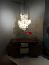 Adesso filled a corner with a 1950s jacaranda desk by Joaquim Tenreiro, a 1950s Louis Kalff table lamp and a Kalmar chandelier.