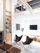 Living Room, Ottomans, Gas Burning Fireplace, and Chair A pair of black leather butterfly chairs face off with Corbusier ottomans in front of the concrete-edged fireplace.  Search “immersive and virtual architecture edge physicality” from Come Sail Away