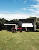 To accompany and complement his family's main house, architect Gerald Parsonson designed this easy, informal shed that adequately addresses the beachy life of the family. The site includes a boat shed and a tractor the family uses to pull their boat to and from the ramp.