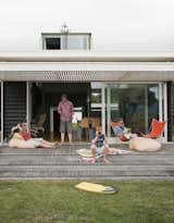 Outdoor, Grass, Wood Patio, Porch, Deck, and Small Patio, Porch, Deck The family spends summers and school vacations at the bach. New Zealand's relatively mild winters mean they use the house year-round.  Photos from Bach to the Beach