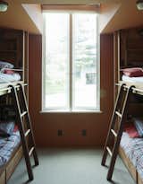 Kids Room, Bedroom Room Type, Bed, and Bunks The guest room cleverly shoehorns four bunks into a small footprint.  Photo 5 of 5 in Rolling Ladders in Modern Homes by Zach Edelson from Bach to the Beach