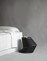 Aranda/Lasch's piece is made from a single ten-foot-long gold zipper, black leather, and a vinyl composite structure. The piece unzips to reveal a dark pink velvet lining.  Photo 1 of 11 in The Nightstand, Reinvented by Jaime Gillin