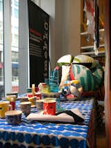 This tabletop display features mugs with Marimekko's iconic Unikko pattern designed by Maija Isola in 1964 as well ceramics with Maija Louekari's black dots Räsymatto design and her blue-on-white Siirtolapuutarha pattern, among others.