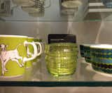 Displayed between a mug featuring Miina Äkkijyrkkä's Iltavilli design with a young calf and a bowl with Maija Louekari's colorful Räsymatto pattern is Anu Penttinen's Sukat Makkaralla glasses, designed in 2010 and available in a range of colors.