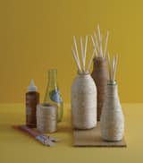Pellegrino bottles wrapped in twine become DIY diffusers. "This project takes advantage of the fact that you can buy little jars of essential oils for reed diffusers instead of buying the whole kit," writes Danny in the book.