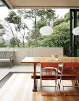 Dining Room, Pendant Lighting, Table, Chair, and Light Hardwood Floor The home’s sliding doors blur the boundaries between inside and out.  Search “you wont believe cozy home inside converted grain silo” from Make Your Parents Happy by Building Them a House
