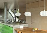 The hanging Iko Iko pendants in the kitchen add a vertical touch to a space and help frame the views outside.