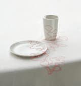 1999

Embroidered Tablecloth continues patterns derived from Ming vases across plates and cups.