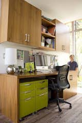 The office is hidden behind the first living area, completely removed from a visitor’s field of vision. It gives the owners a private place to work, while still keeping them connected to the rest of the home. It is a clever use of space says one visitor.