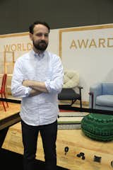 Dwell's Kyle Blue in front of the Modern World Awards exhibit at Dwell on Design.