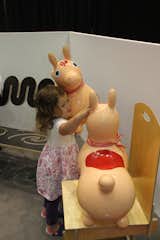 A small visitor tries out a non-toxic rubber Rody horse from Plastica.