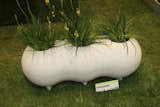 Tile designer Daniel Ogassian, who designed a paver that invites grass to grow up through it, brought his undulating tri-form planter.