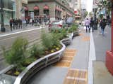 There are eight parklet sections over the two blocks of Powell St. just north of the famous cable car turnaround. The street is a popular shopping district just south of Union Square that is routinely mobbed by locals and tourists alike. Undoubtedly the widening of the sidewalks, and narrowing of the street, will cause some growing pains, but as an investment in the pedestrian streetscape, this is a wonderful step.  Search “powell-st-parklet.html” from Powell St. Parklet