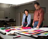 Studio member Eri Shimatsuka (left) and studio manager Petri Juslin (right) compare a first fabric proof to the artist’s original drawing.