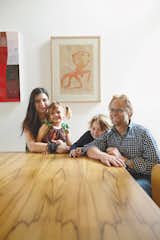 Wilkin and Pini, together with their children Ava and Tom, sit at a dining table made from black heart sassafras, an Australian wood.