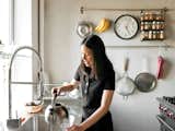 Sherman’s friend Anna Chang prepares tea in the kitchen. The range is by Wolf. Walls are coated with parging, a type of concrete made with sand instead of gravel—-more typically used in an industrial context.
