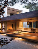 Protected by an overhang, and floating above ground level, this tertiary space is known in traditional homes as the "engawa." To sustain a unified look throughout, the floor and ceiling are clad in ipe wood. 