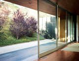Windows and Sliding Window Type A custom-tailored mechanism allows six floor-to-ceiling sliding glass doors to open along the entire width of the living space, creating a seamless transition from indoors to out.  Search “glass-door” from An Atypical Modern Home in Southern California
