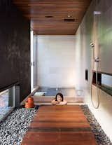 At the opposite end of the house, the soaking tub gets almost daily use. The bath and shower fixtures are by Dornbracht