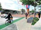 The Street Life Plan projects each fall into one of six categories: (1) anchoring the heart of the district, (2) promoting the alleys, (3) making new social spaces, (4) improving sidewalks for street life, (5) promoting walking and biking, (6) and promoting sustainability. This rendering shows the proposed redesign of Howard Street between 3rd and 4th streets, which connects two of the Moscone Center convention buildings. The space, currently serving through-traffic only, will be literal and social center of the district in the new plan.  Photo 2 of 12 in Yerba Buena Street Life Plan by Miyoko Ohtake