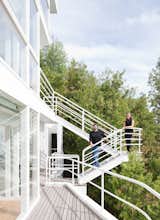 Michael McCarthy and Marcia Myers on the exterior promenade.  Photo 11 of 22 in This Lake House Is a Living Piece of Architecture History
