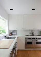 The "Meier white" extends even to the kitchen, which has been updated with new appliances.