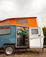 In travel mode, the Cricket Trailer measures 15 feet long, six and a half feet wide, and six feet ten inches tall (ground to roof), but when the top is popped up, it provides six feet two inches of interior headspace.
