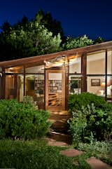 Michl's awning was devised to replace a previous wooden one that blocked views of the nearby mountains. See how the awning catches the light at night, yet another benefit of the crystalline design.