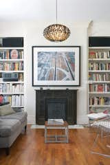 Living Room The living room in the original house has Victorian details, but the furniture—vintage Bertoia chairs, a Gloss floor lamp by Pablo Pardo, and a Norm 03 Steel Pendant Lamp by Normann Copenhagen—brings the look up to date.  Photo 1 of 5 in Modern Addition in Louisville