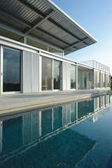 In Hobe Sound, Florida, this passively cooled residence overlooking a custom-built water-ski circuit is hardly par for the course. “The home is really driven by exposure to the landscape,” says architect Scott Hughes. Read the full story here.  Photo 1 of 9 in Ski for All