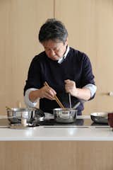 Shown here, Fukasawa busy over the cooktop.