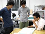 Yasuaki Onoda and his students at work on models for the reconstruction.