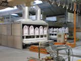 The ceramics are fired in a 340-foot-long, 2,200-plus-degree kiln. The sinks, toilets, and tubs are tinted either pink or blue from the glazing but come out a pure white on the other side.
