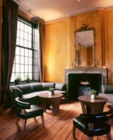 This was my favorite single space in the hotel—a lounge with a big marble fireplace, gilt mirror, and weathered wooden floor boards.  Photo 14 of 21 in Arkansas by Rob Evans from The Dylan, Amsterdam