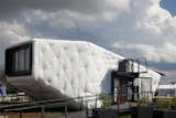 SCI-Arc and Caltech teamed up to create this uber conceptual "outsulated" home called CHIP, which stands for "Compact Hyper-Insulated Prototype. Underneath the layer of white architectural-grade vinyl is 15 inches of batted denim insulation. By moving the insulation to the outside of the home, there's more space inside, said one of the student representatives. The planters in the foreground are irrigated by the home's graywater system.

Photo courtesy of the DOE.