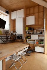 The interior is designed for flexibility. The floor of one level becomes a table and the cabinets and shelves can be configured at will.
