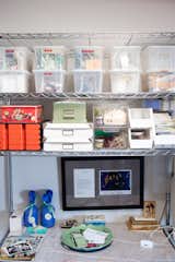 Lynda's knick knacks and crafty supplies are kept in the kitchen's metal shelving system, which came with the couple from their previous apartment.