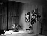 The living room in early 1950, with a circa 1944 three-legged molded-plywood side chair (the couple made one with two legs in the front and one in back, and vice versa). Early on, the pair often laid down Japanese goza mats on the concrete floor, before they had the tile put in. Photo courtesy the Eames Foundation.