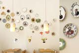 A clever bit of decor, and one that offers a bit of teashop charm, is this wall of plates. The plates are emblazoned with silly animals in formal dress who look more like they should be consuming fancy cheese than producing it.