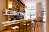 This bar, made of Corian with chairs made of chestnut by Gabriel Corchero Studio, is near the front entrance. It's a bit tough to see in this photo, but the facade has a series of vertical cedar slats.