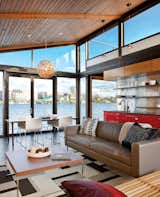 The floor-to-ceiling windows at either end of a Seattle boathouse allow light to stream through the entire 1,000-square-foot space.