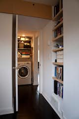 In just nine square feet, the linen closet down the hall holds a washer, dryer, on-demand hot water heater and shelves for storage.
