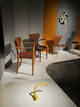 In one corner of the show, a bright yellow Vola faucet, designed by Arne Jacobsen and Teit Weylandt in 1969, holds court with a tribe of wooden chairs from the 1940s and 50s.
