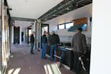 At the end of the day, Abbie, Stella and some of the Marmol Radziner staff gathered in the kitchen. "You can see the range hood in the background, the white tiled back wall of the kitchen, and seam in the ceiling where the two modules are joined," says Bill.