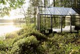 This dreamy, glass bedroom by the lake was created as an early prototype for the prefabricated greenhouse/she kits known as the Kekkilä Green Sheds. 